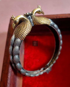 Thea's Silver Look-Alike Peacock Shaped Screw Bangle